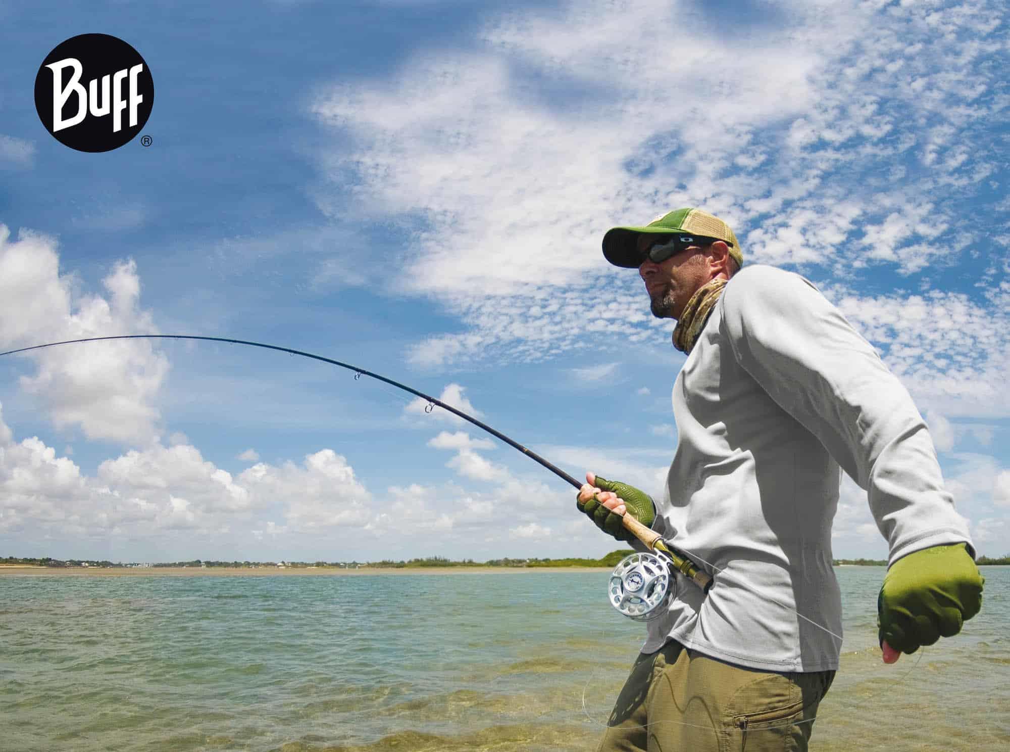 Side landscape shot of a fly fisherman on the water. He is wearing a long sleeved shirt and a High UV Buff® as scarf. The weather looks undecisive. It could be cool and warm within the hour. Source: buff.eu Copyright: Distributed for the promotion of the High UV Buff® in Fishing
