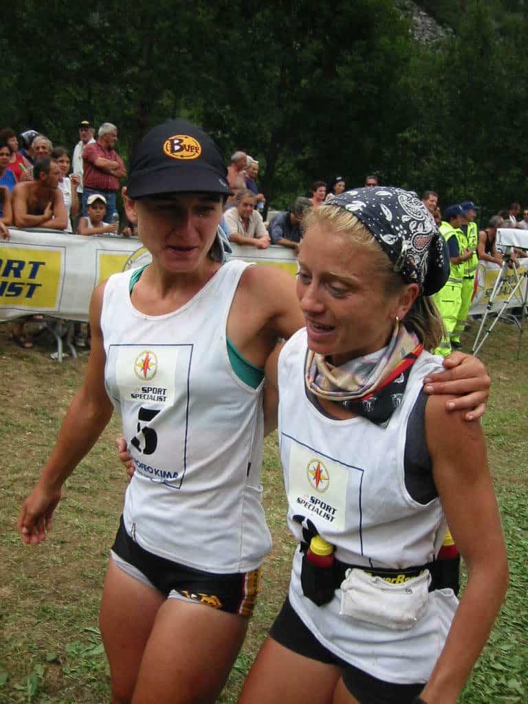 A portrait side shot of two women walking together. It seems to be shortly after crossing the finish line of a trail run. The one on the left is wearing a Cap Buff®. The one on the right is wearing two High UV Buff®. One as neck cooler & one as alice band. The seem both tired and happy.