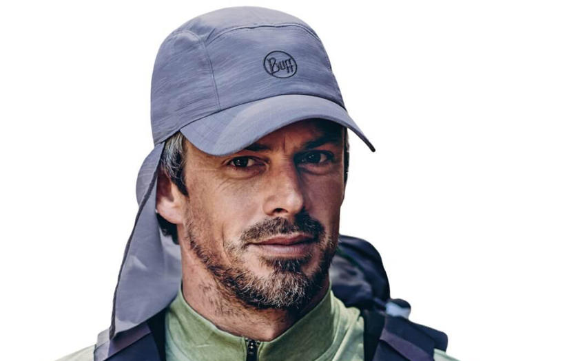 A studio photo of a man wearing a Buff® Bimini Cap. The man is wearing trekking gear and looks very fit. Source: buff.eu