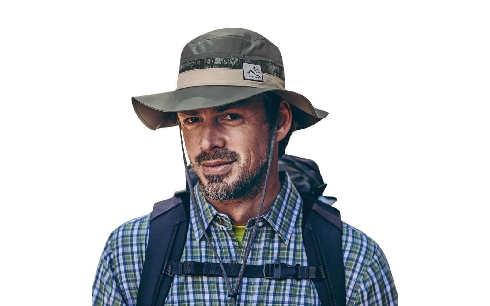 A studio photo showing a mid-aged man wearing a Buff® Booney Hat. The man is wearing a checkered flannel shirt and wearing a day backpack. He is looking into the camera. Source: buff.eu