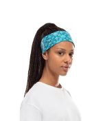 Studio photo of a Woman wearing the BUFF® Coolnet UV+ Design "Balmor Pool” as a headband. Source: buff.eu