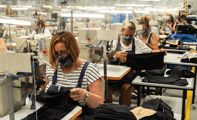The image shows women sewing BUFF® products in the factory in Igualada, Spain, Europe. Source: buff.eu